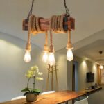Suspension corde au style industriel en bois allumée dans une salle à manger