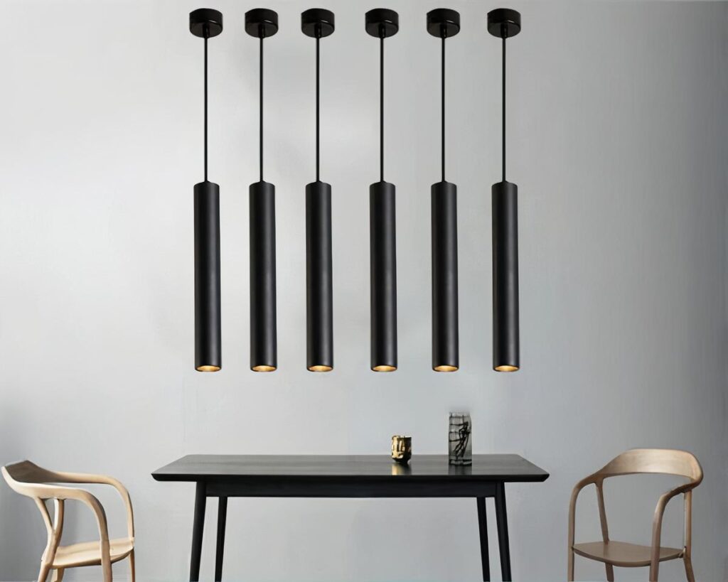 Suspension tube noire design et moderne allumée dans une salle à manger