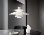 Suspension métal LED à étage style minimaliste installée au-dessus d'une table en marbre noir